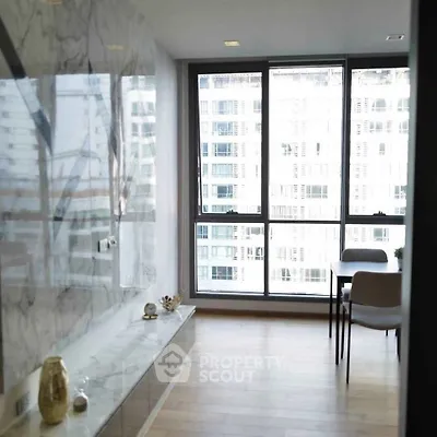 Modern apartment with floor-to-ceiling windows and elegant marble accents.