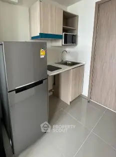 Modern compact kitchen with sleek appliances and minimalist design