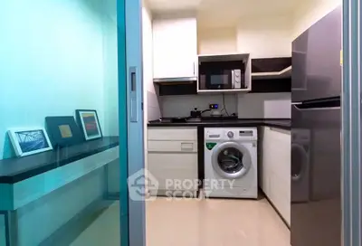 Modern compact kitchen with washing machine and sleek appliances