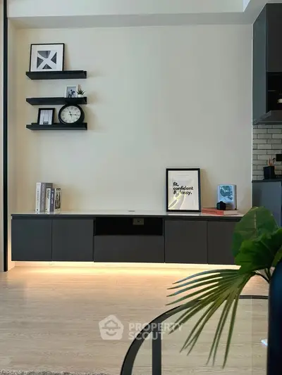 Modern living room with sleek shelving and stylish decor in a contemporary apartment.