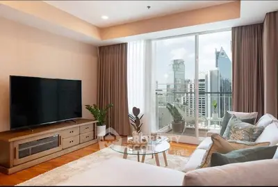 Modern living room with city view, stylish decor, and large TV