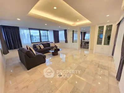 Spacious living room with elegant marble flooring and large windows offering city views.