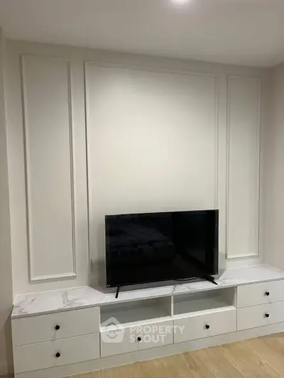 Modern living room with sleek TV stand and mounted flat-screen TV