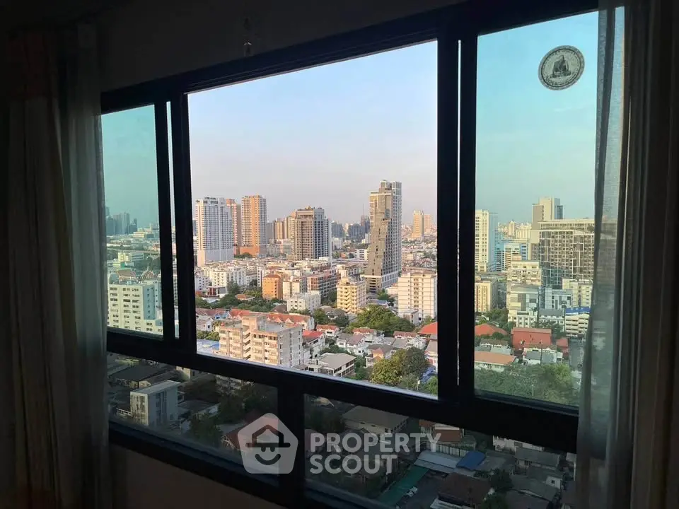 Stunning cityscape view from a high-rise apartment window, showcasing urban skyline and vibrant city life.