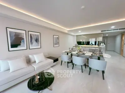 Luxurious open-plan living room with elegant dining area and modern decor.
