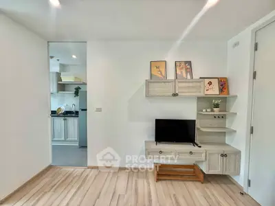 Modern living room with stylish TV stand and open kitchen view