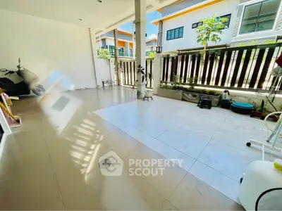 Spacious covered patio with tiled flooring and garden view in modern home