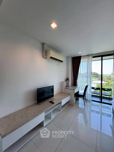 Modern living room with sleek design, large window, and air conditioning, offering a bright and airy atmosphere.