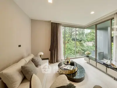 Elegant living room with large windows and garden view, featuring modern decor and cozy seating.