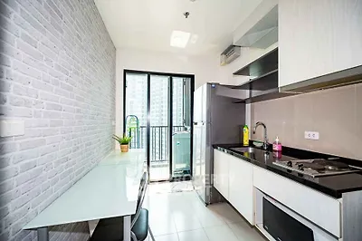 Modern kitchen with sleek design and balcony view in urban apartment