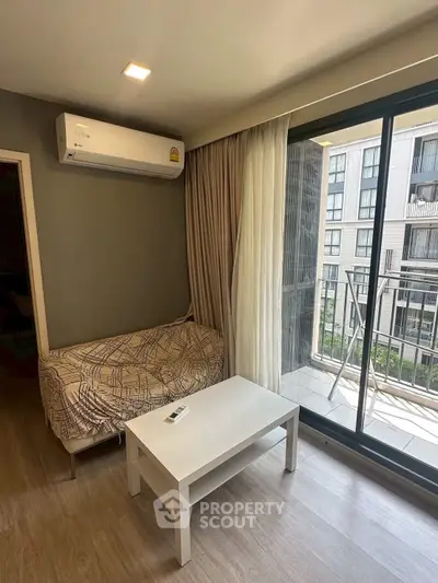 Modern living room with air conditioning and balcony view in urban apartment.