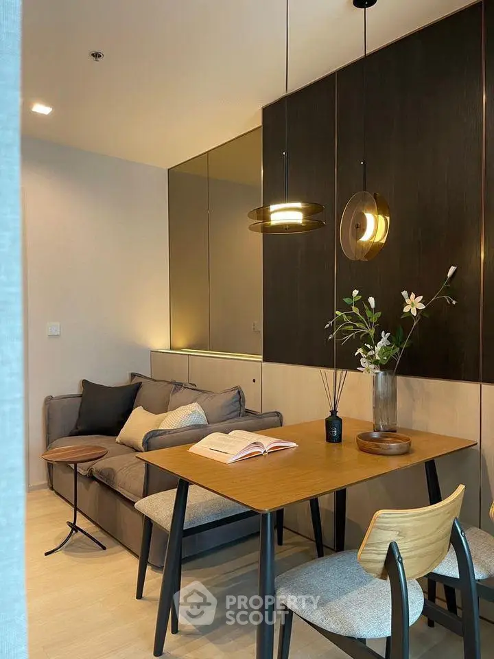 Modern living room with stylish dining area and cozy sofa, perfect for urban living.