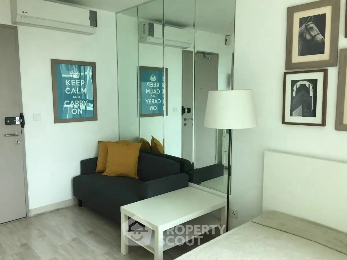 Modern living room with mirrored wall and cozy seating area