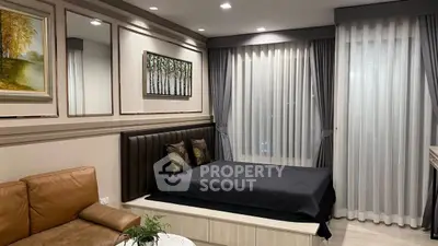 Elegant bedroom with modern decor and cozy seating area, featuring stylish curtains and ambient lighting.
