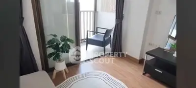 Cozy bedroom with balcony access and stylish decor in modern apartment.