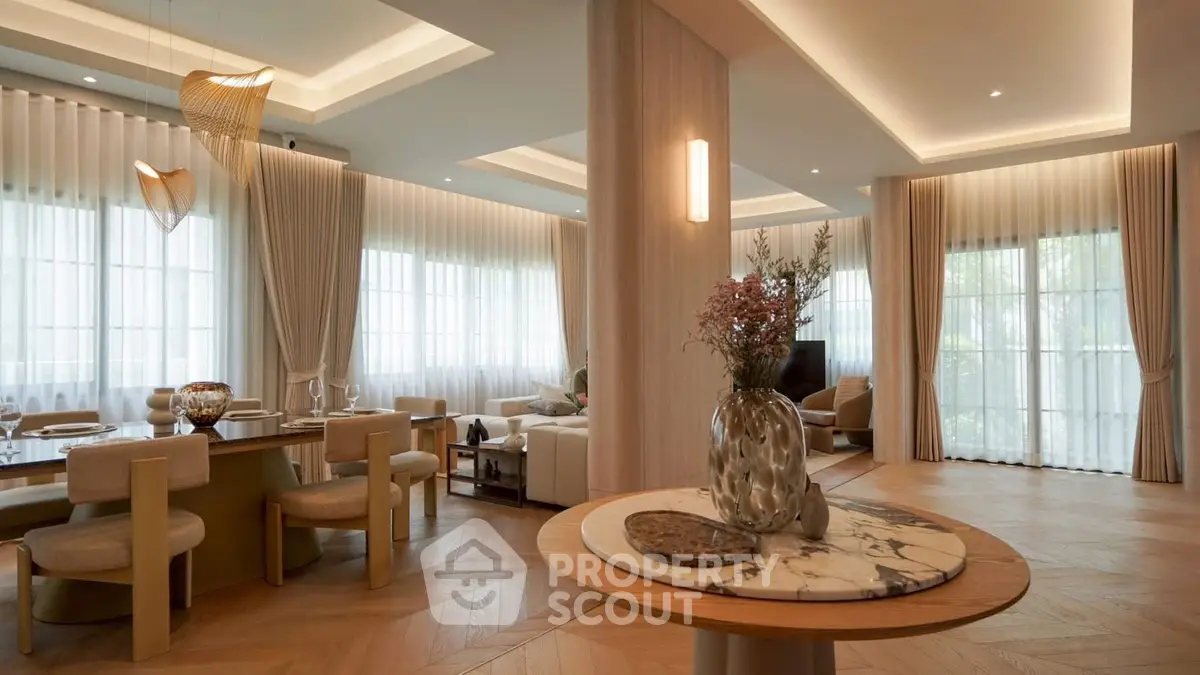 Luxurious open-plan living and dining area with elegant decor and natural light.