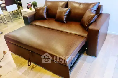 Luxurious brown leather sofa bed in modern living room setting