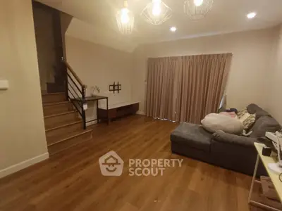 Cozy living room with wooden flooring and modern lighting