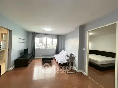 Spacious living room with city view and adjacent bedroom in modern apartment.