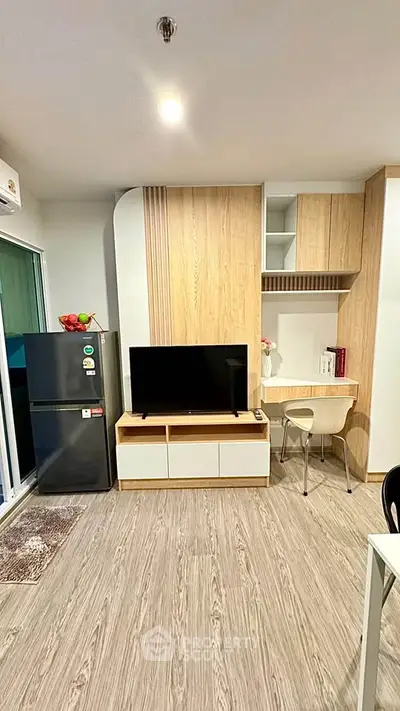 Modern living room with sleek TV unit and compact workspace