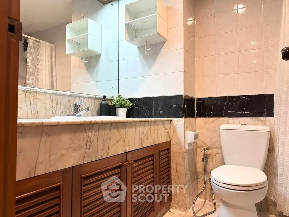 Elegant bathroom with marble countertop and modern fixtures in a stylish real estate property.