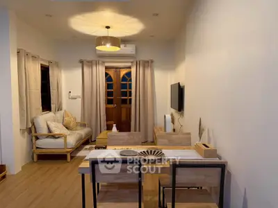 Charming living room with cozy seating and elegant dining area, perfect for relaxation and entertaining.