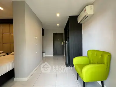 Modern apartment interior with vibrant green chair and sleek design