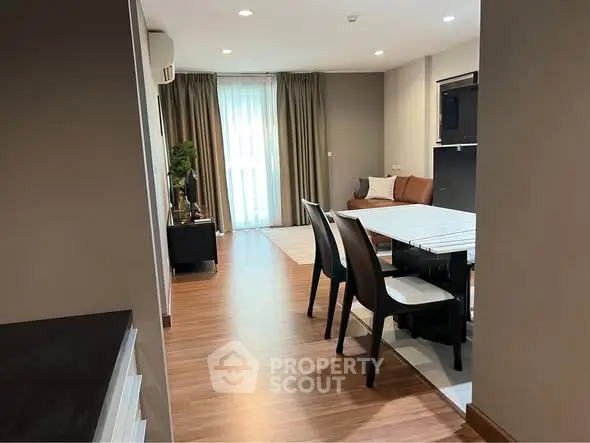 Modern open-plan living and dining area with stylish furniture and natural light.