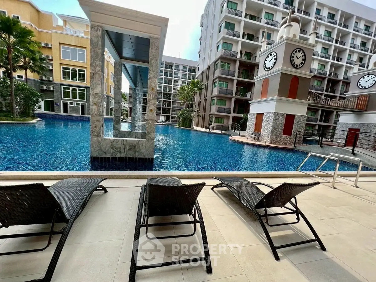 Luxurious poolside view with modern architecture and relaxing lounge chairs.