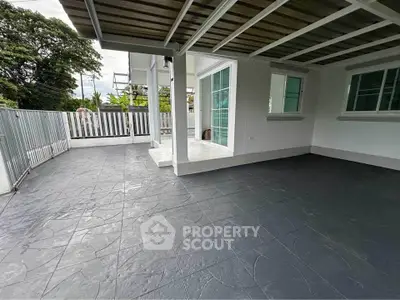 Spacious covered patio with modern design and large windows