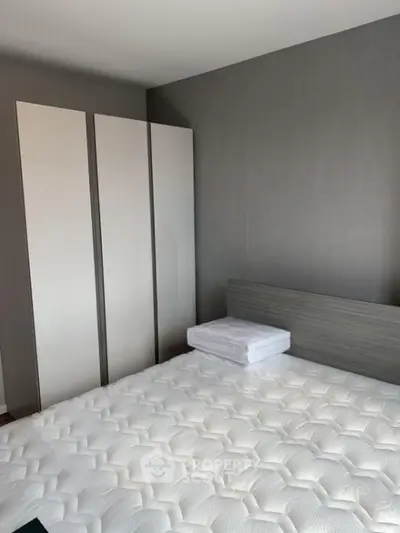 Modern bedroom with sleek wardrobe and comfortable mattress in stylish apartment.