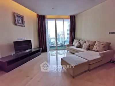 Spacious living room with modern decor and large windows offering city views.