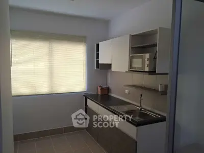Modern kitchen with sleek cabinetry and ample natural light