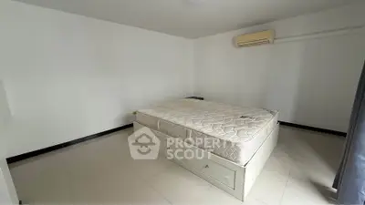 Spacious bedroom with minimalist design and ample natural light