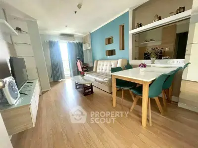 Modern living room with stylish decor and open layout, featuring a cozy sofa and dining area.