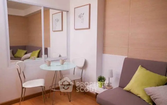 Cozy modern living room with stylish decor and glass table, perfect for relaxation.
