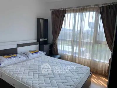 Bright bedroom with large window and modern furnishings