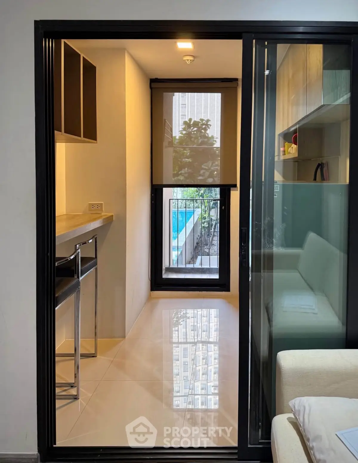 Modern compact living space with sleek design and pool view