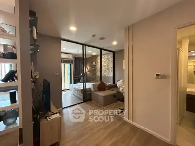 Modern apartment interior with open living room and bedroom layout, featuring stylish decor.