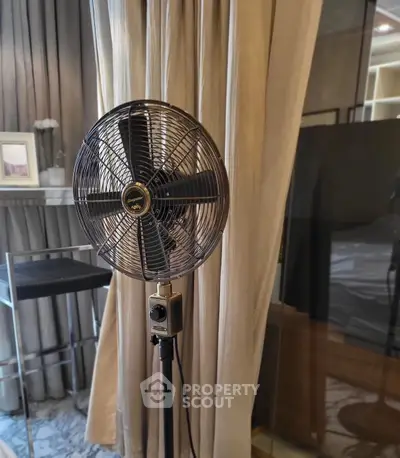 Stylish interior with vintage fan and elegant curtains in modern living space.