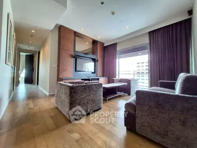 Spacious modern living room with elegant furniture and large windows offering city views.