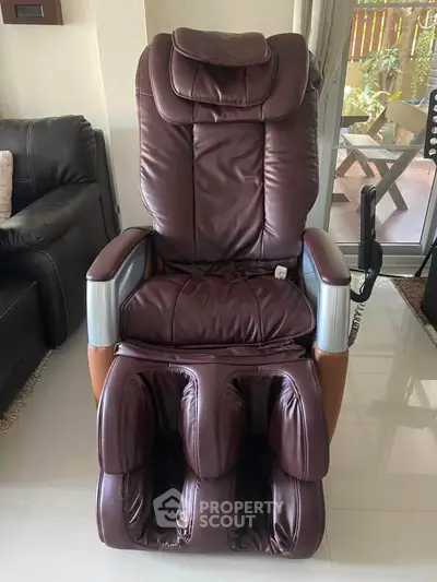 Luxurious massage chair in modern living room with garden view, perfect for relaxation and comfort.