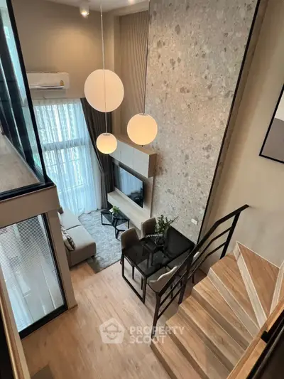 Modern loft-style living room with high ceilings and elegant decor