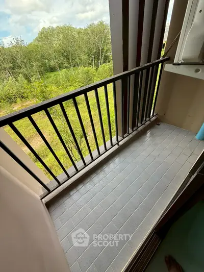 Charming balcony with lush green view, perfect for relaxation and enjoying nature.