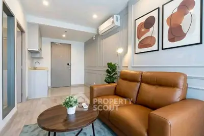 Modern living room with stylish decor and leather sofa in a contemporary apartment.
