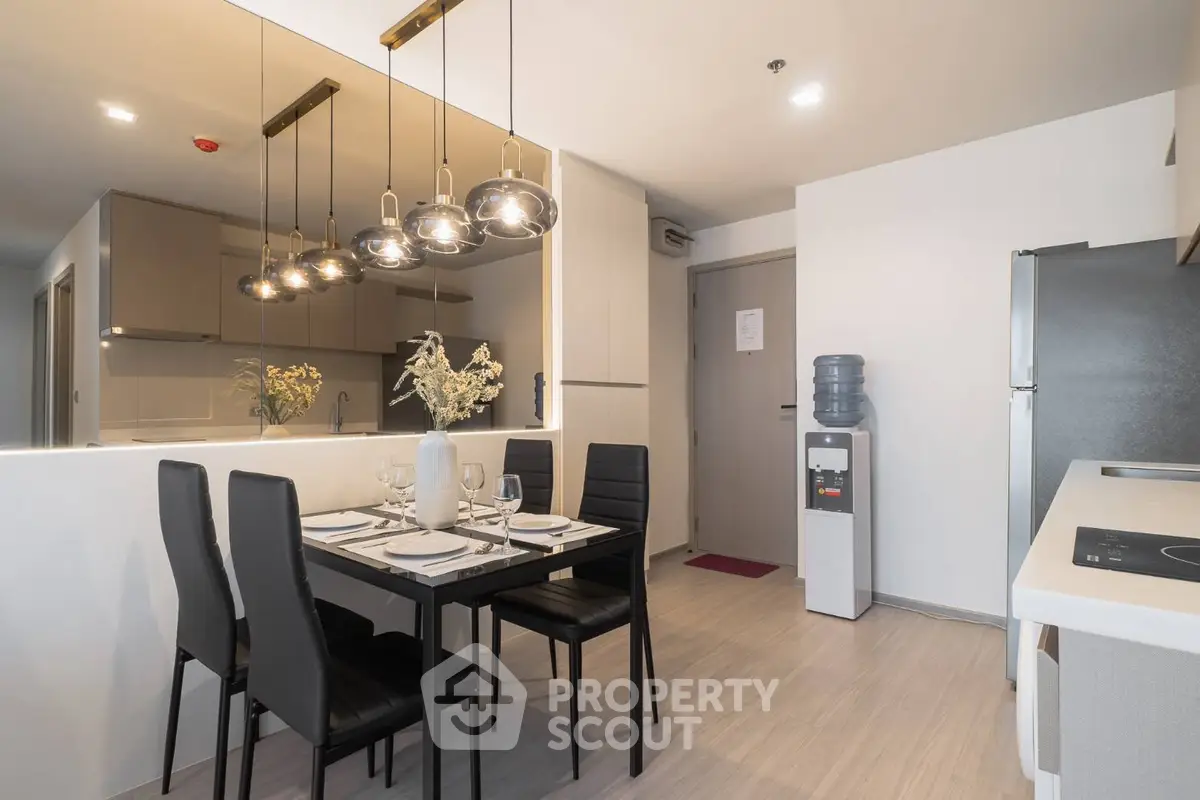 Modern kitchen and dining area with sleek design and elegant lighting