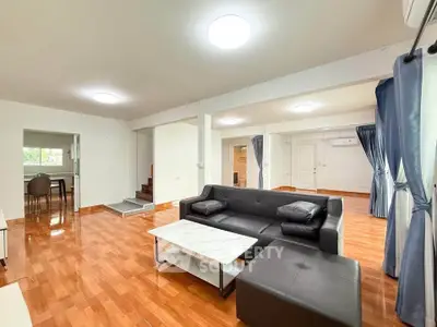 Spacious living room with modern furniture and wooden flooring