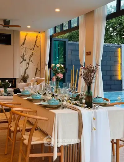 Luxurious dining area with elegant table setting and pool view, perfect for entertaining guests.