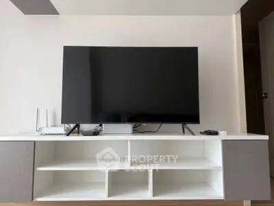 Modern living room with sleek TV setup and stylish storage unit.