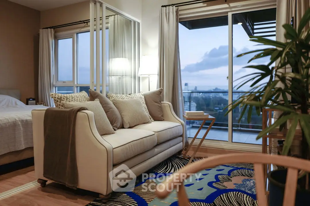 Chic living room with cozy sofa and stunning balcony view at dusk